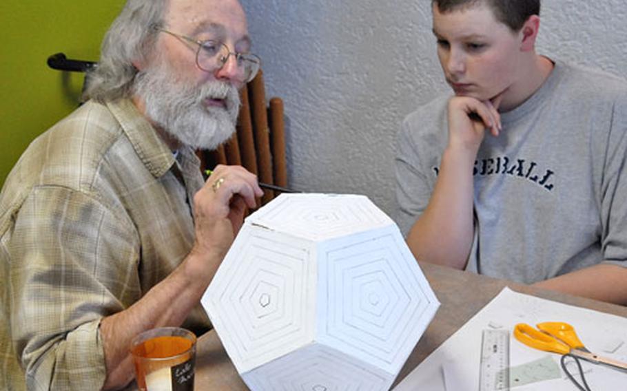 Joey Patridge, right, a Mannheim, Germany, high school freshman, gets pointers from instructor Dick Termes in the 3D polyhedra workshop at this year&#39;s Creative Connections. This year, 148 students participated in the DODDS-Europe visual and performing arts enrichment program, which featured 11 individual workshops.