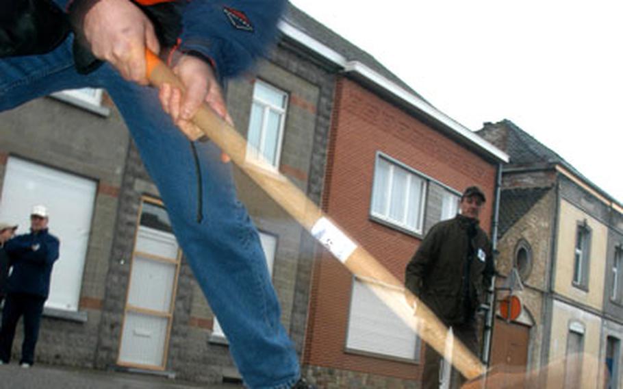 A Chièvres local hits the cholette with his wooden club, called a rabot.