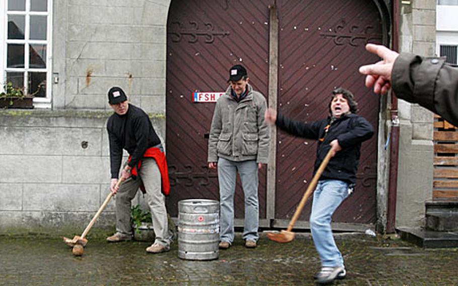 A team celebrates as it is about to finish off a game by driving the chôlette into one of the 18 targets set up around town. This keg was in front of one of the tavern, where the players went to rehash their last round of shots.