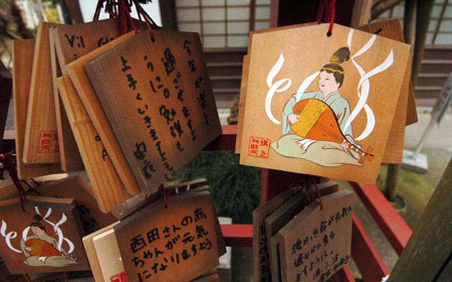 Japanese patrons write wishes on wooden blocks and place them at the Hachimangu shrine for good luck and homage to their gods as part of the Shinto religion.