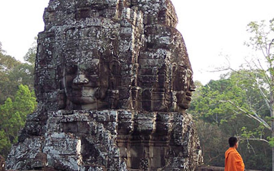 A Buddhist monk looks out from 13th Century Bayon, the last state Hindu temple to be built under the Angkor civilization.