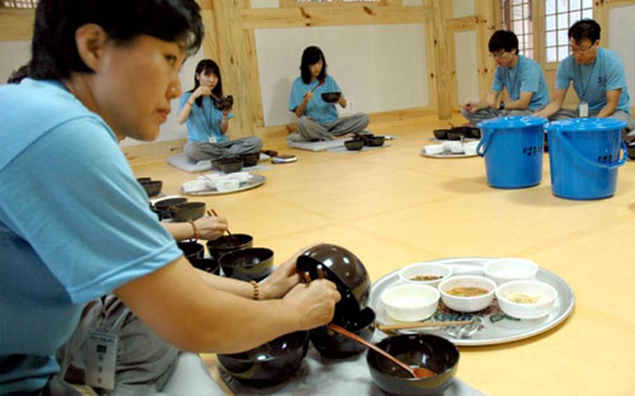 While a simple meal, the monk’s balwoo gongyang requires specific precedures for rinsing each bowl before and after eating. The blue bins collect the last of the bowls’ water; this slurry is inspected by the monks to see whether everyone has properly cleaned his or her bowls.