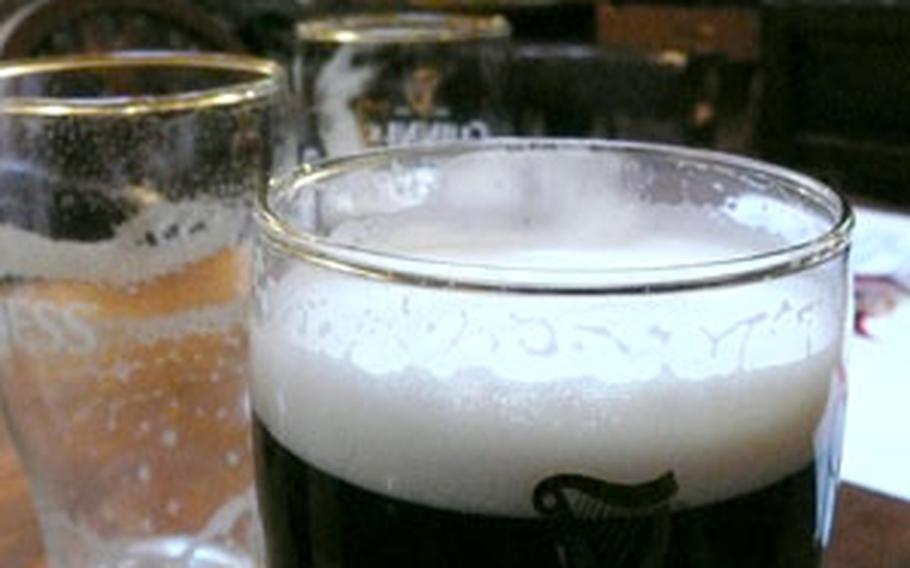 A server delivers drinks to English football fans watching Manchester United at The Talbot.