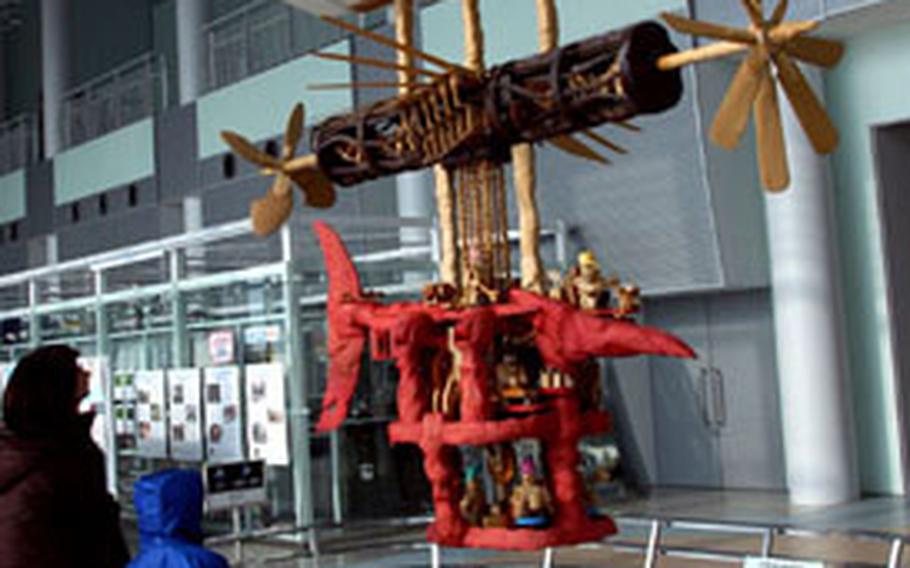 A wooden flying contraption inside the entrance to the Misawa Aviation and Science Museum represents the dream of flight in a fairy-tale style, according to a museum guidebook in English. The museum has a gift shop, small restaurant, aviation library and indoor and outdoor park.