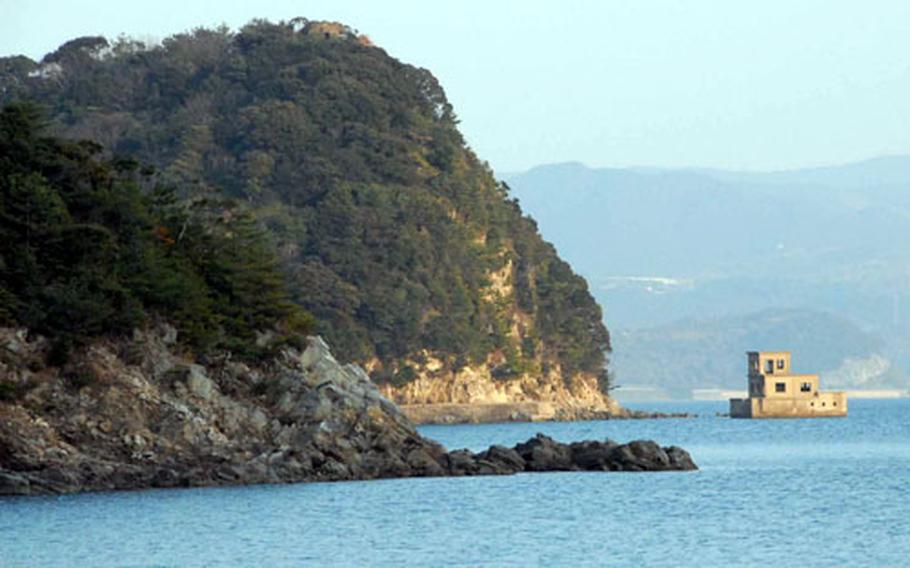 The setting sun lights the shores of Omura Bay at Osaki campground, which is near Sasebo, Japan.