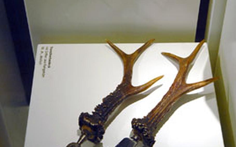 A 19th-century carving set and 18th-century tableware,all made with deer-antler handles, are on display at the Jagdschloss Kranichstein, a former hunting lodge.