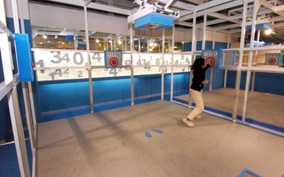 A child plays a game involving buttons attached to the walls, floor, and ceiling.