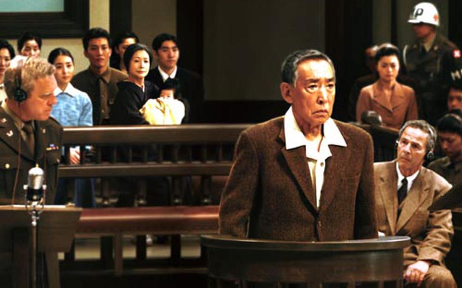 Lt. Gen. Tasuku Okada (Makoto Fujita) is testified at the Yokohama Disrict Court while Chief Prosecutor Attorney Richard F. Burnett (Fred McQueen, left) and Lt. Gen. Okada&#39;s attorney Dr. Joseph Featherstone (Robert Lesser, right) are listening.