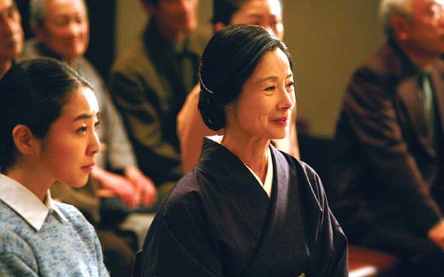 Atsuko (Sumiko Fuji), wife of Lt. Gen. Tasuku Okada stands along with her son&#39;s(Akira) fiancee, Junko, (Hana Konoe) at the Yokohama District Court.