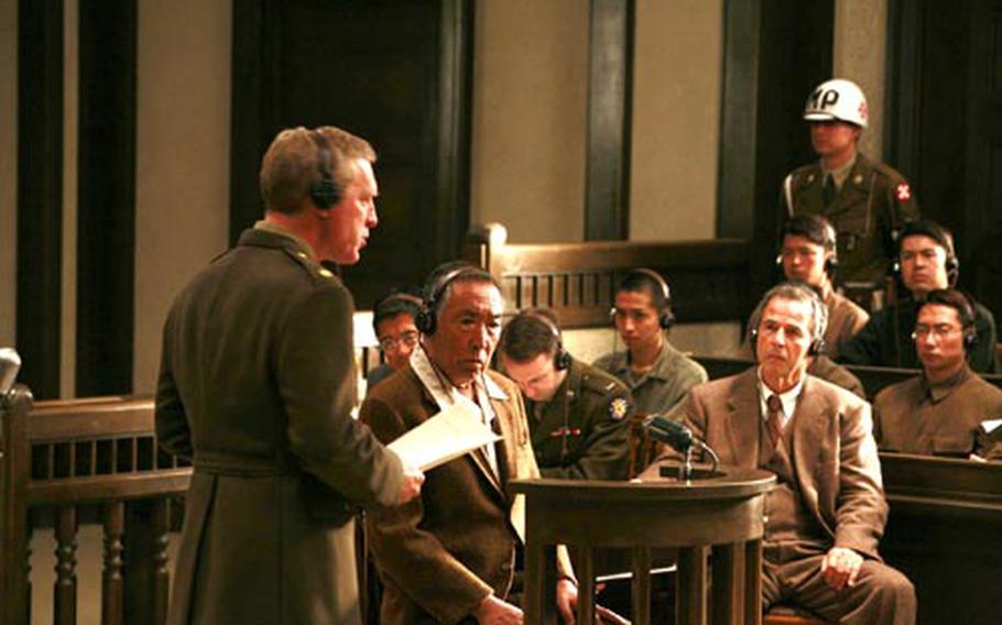 Chief Prosecutor Attorney Richard F. Burnett (Fred McQueen), left, is questiong to Lt. Gen. Tasuku Okada (Makoto Fujita), center, beside his attorney Dr. Joseph Featherstone (Robert Lesser). Photo courtesy of "Best Wishes for Tomorrow"/Asmik Ace.