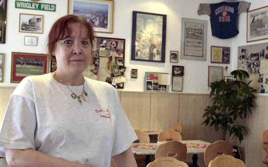 Romeo&#39;s Diner owner Diana Torz stands in her restaurant in front of the Chicago mementos hanging on the wall. Since 1986, Romeo&#39;s has been making Chicago-style deep-dish pizza.