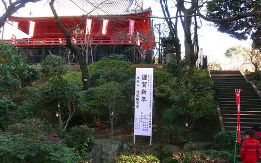 Visitors walk up stairs before entering the Kiyomizu-dera Temple, one of many shrines at Ueno Park.