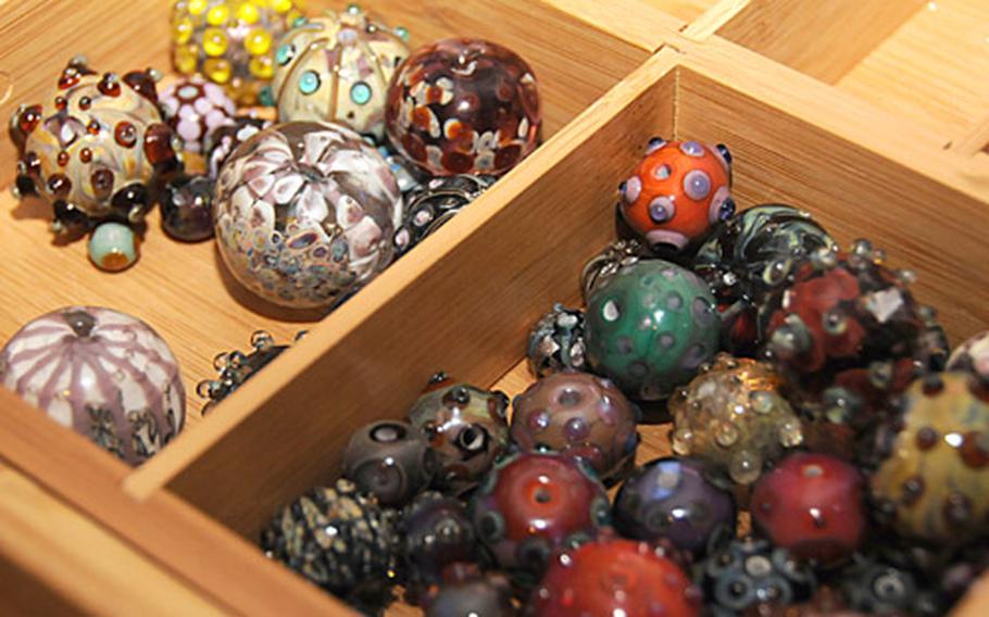 "Each bead is a work of art," Julia Landecker says of the glass beads she makes in a workshop in her home. She finds it easier to just create numerous beads and then build jewelry from them, rather than try to create a set of beads for a specific peice of jewelry.