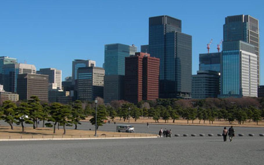 Visitors walk through the large open areas surrounding the Imperial Palace. The grounds around the palace act as a park, much like Central Park in New York City.