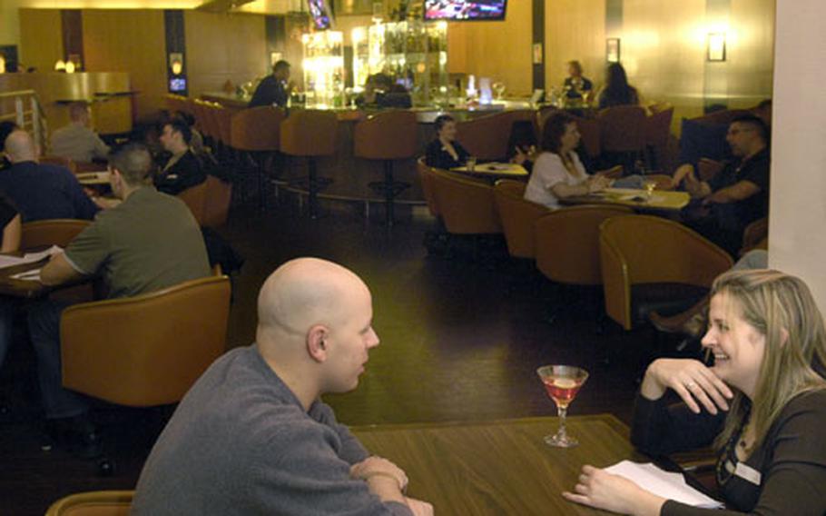 Air Force Staff Sgt. Jennifer Babb listens as a potential suitor attempts to leave a good first impression during an evening of speed dating at Martini&#39;s Lounge on Ramstein Air Base in January. The goal of speed dating is to give 20 men and women a chance to spend 10 minutes together in the course of an evening to hopefully find a match through an anonymous selection process.