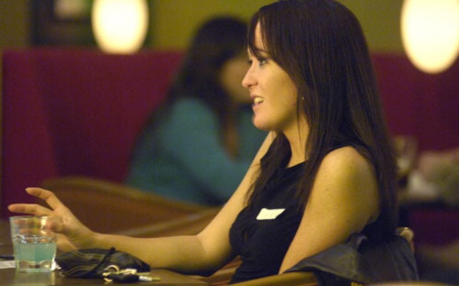Air Force Staff Sgt. Rose McKinney listens over a drink as a potential suitor attempts to leave a good first impression during an evening of speed dating at Martini&#39;s Lounge on Ramstein Air Base in January. The goal of speed dating is to give 20 men and women a chance to spend 10 minutes together in the course of an evening to hopefully find a match through an anonymous selection process.