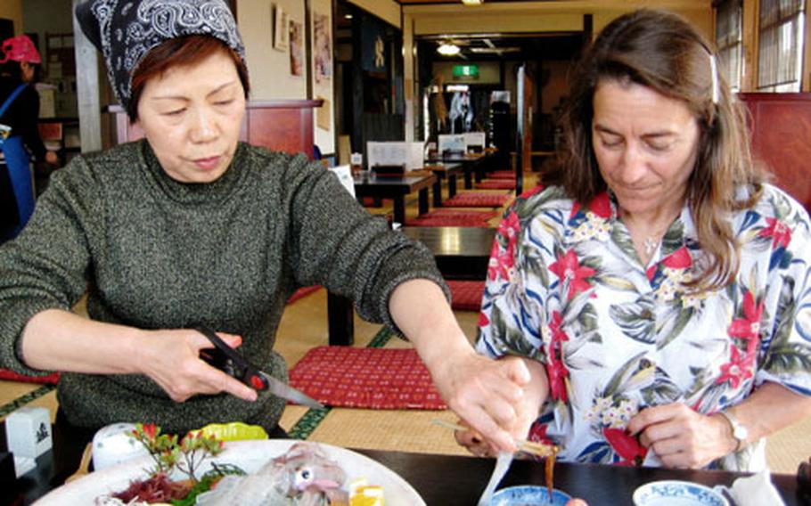 Kitty Clarke tries to work up the courage to eat live scallops — er, make that squid — at a restaurant in Yobuko Fishing Village in Karastu. The waitress cut off the tentacles, then Kitty watched them squirm around in her soy sauce.