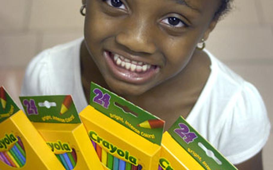 Shannon McCray, 6, shows off some art supplies in the back-to-school section of Ramstein’s base exchange.