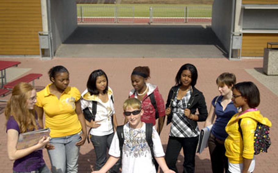Matthew "Frog" Cremeans, 11, strikes a pose among high school girls gathered outside Ramstein’s base exchange, as they prepare for a new school year.