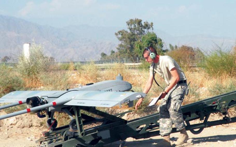 Sgt. Jeremy Squires, 26, from Wellsboro, Pa., checks a Shadow unmanned aerial vehicle Jalalabad Air Field, Afghanistan.