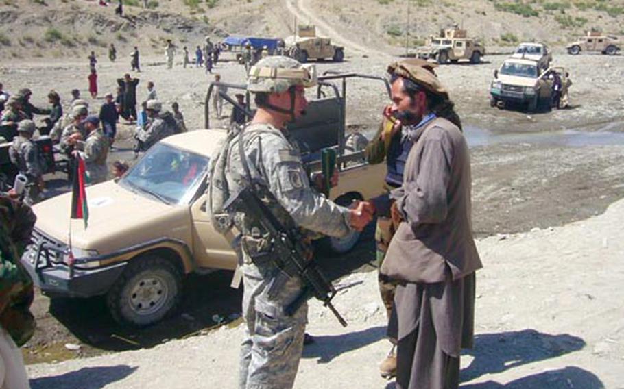 1st Lt. Nate Hepler meets with a local Afghan leader during a fathering of U.S. forces, Afghan National Army troops and locals. Sky Soldiers drew crowds wherever they went in Afghanistan.