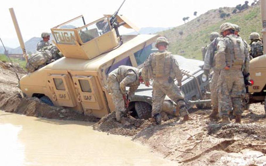 Soldiers from 1st Battalion, 503rd Infantry Regiment had to deal with a variety of weather conditions during their 14-month tour in Afghanistan. Here, soldiers from Company A have to get their Humvee out of the mud where it got stuck during a mission.