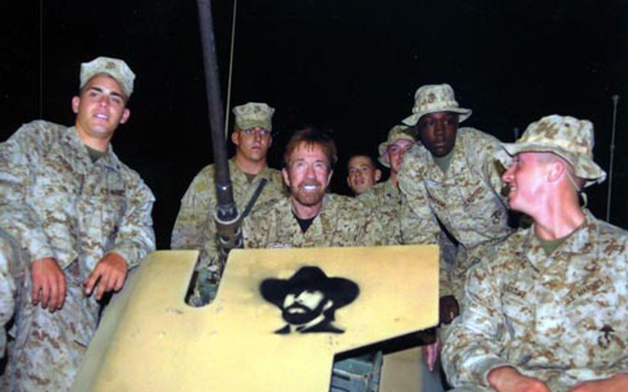 Actor Chuck Norris spends some time with troops during a USO trip to Iraq.