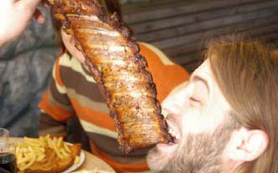 Christian Hahn of Wittlich, Germany, tears into a slab of baby back ribs during a recent visit to the Waldgeist Restaurant, located near Hofheim between Frankfurt and Wiesbaden. In addition to oversized plates of ribs, the restaurant offers super-duper large schnitzels, sausages, cheeseburgers and rumpsteaks. “It was a touch too much,” Hahn said after his feast.