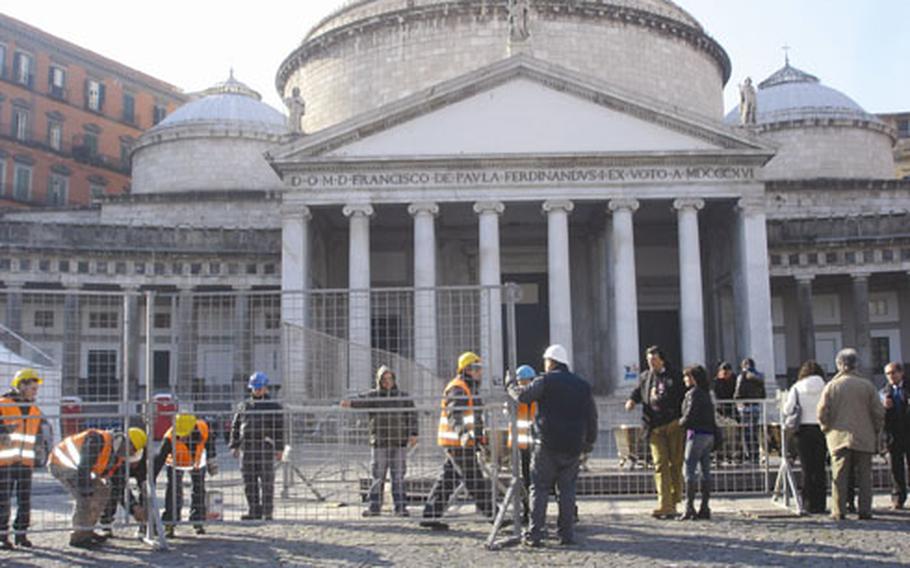 Construction workers prepare for the Grand New Year’s Eve concert in Piazza Plebiscito in Naples