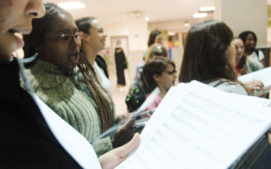 Cast members rehearse for the spring debut of "Aida," a modern take on Verdi’s classical opera. Members of the U.S. Navy base, both active duty and their families, make up the raucous cast of amateurs — who vow to present the public with a professional production.