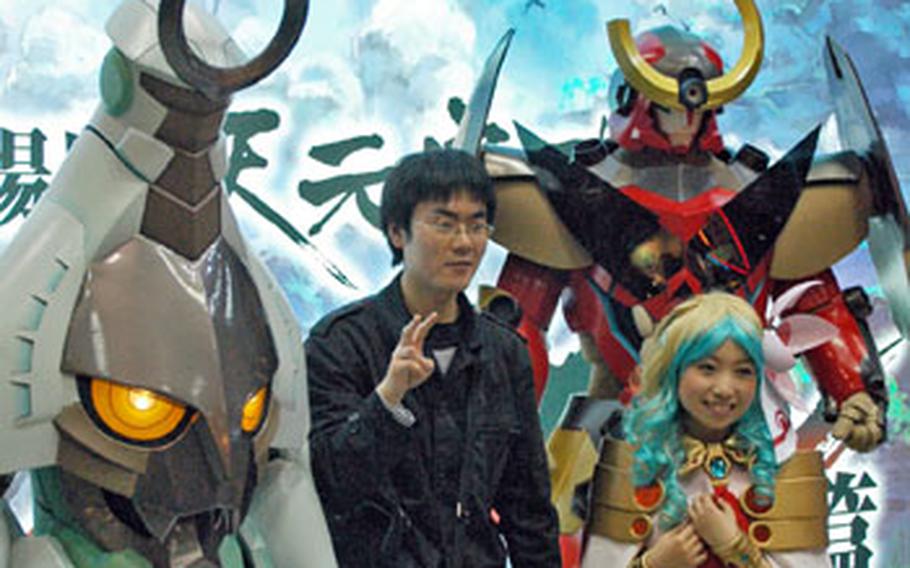 An anime fan poses for a picture with exhibitors dressed as anime characters at the Tokyo International Anime Fair.