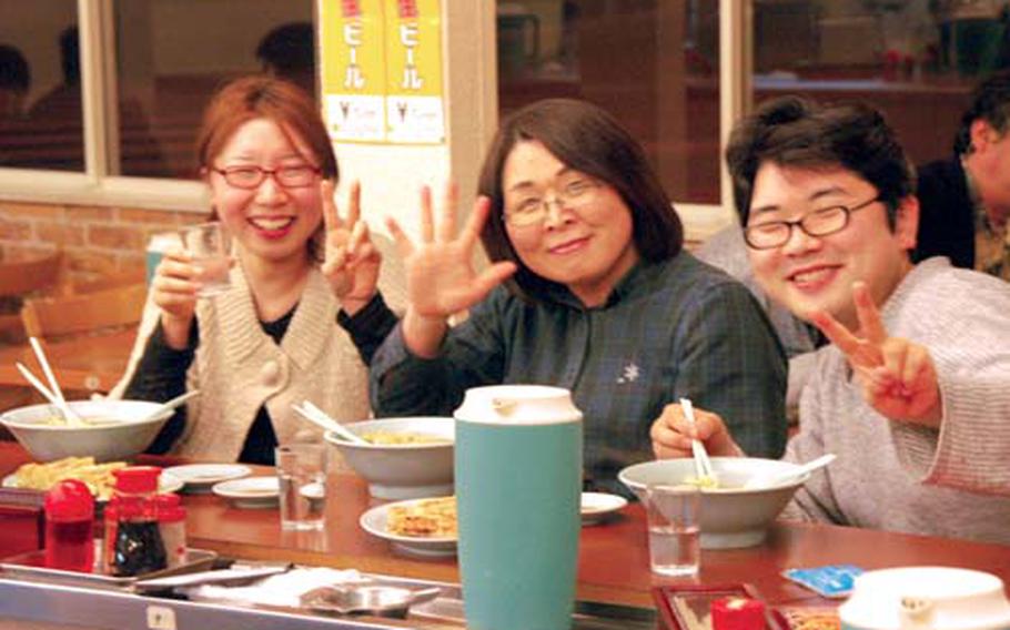 Japanese patrons dig into their bowls of Ramen and gyoza recently at Manhokutei.
