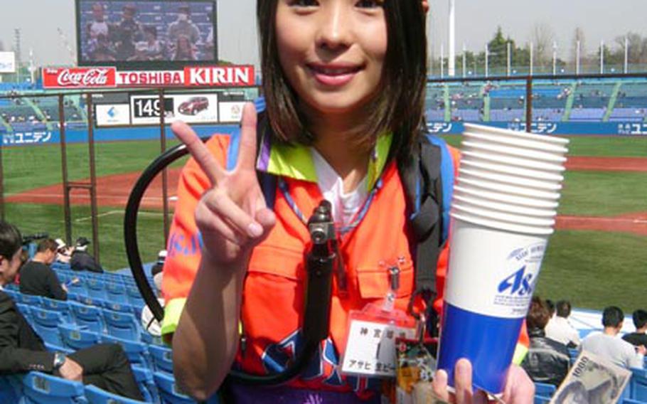Vendors with beer kegs on their backs serve beer at Japanese baseball stadium like this girl at Jingu Stadium in Tokyo.