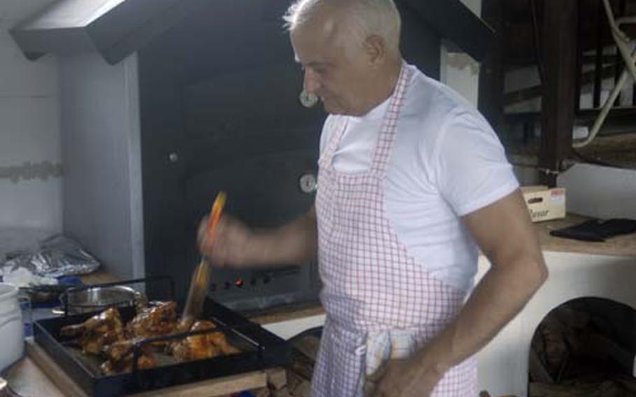 A cook at Am Silbersee in Landstuhl, Germany,slathers chicken with some tasty bastings. The hard-to-find restaurant specializes in rotisserie-style chicken.