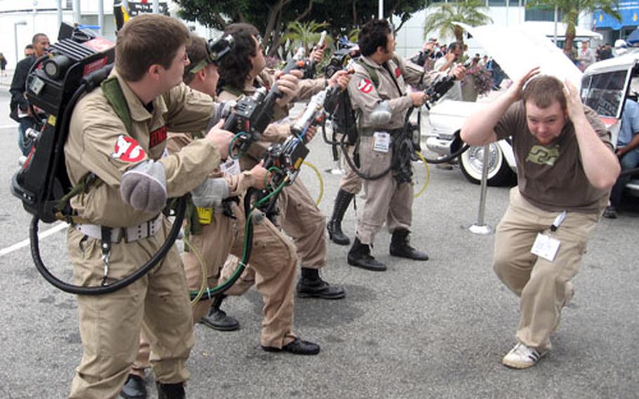 An attendee at the Electronic Entertainment Expo in Los Angeles pretends to flee in terror as actors pretend to fire proton packs at a supernatural foe. The actors were at E3 Tuesday in support of Atari’s upcoming "Ghostbusters: The Video Game."