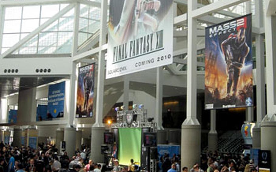 An immense poster for "Final Fantasy XIII" looms over attendees Tuesday at the Electronic Entertainment Expo at the Los Angeles Convention Center.