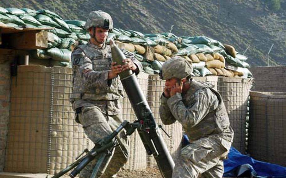 Pfc. Sergio Abad, right, covers his ears just before his mortar fires on an enemy position at Camp Blessing on June 21, 2008. Three weeks later, Abad was among nine soldiers killed defending their vehicle patrol base in Wanat, Afghanistan.