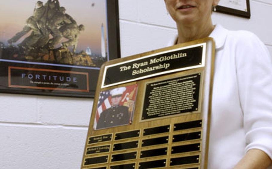Ruth McGlothlin in her office at Lebanon High School, with the plaque listing the recipients of the scholarship honoring her son, 1st Lt. Ryan McGlothlin.