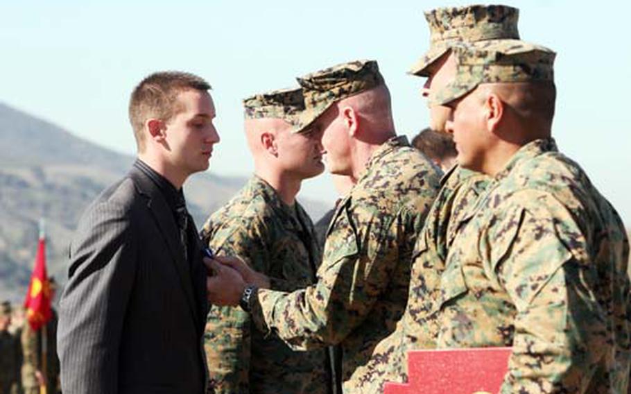 Lance Cpl. Joshua R. Mooi, a 22-year-old from Bolingbrook, Ill., is awarded the Navy Cross by Col. Robert G. Oltman during an awards ceremony at Camp Pendleton on Jan. 8.