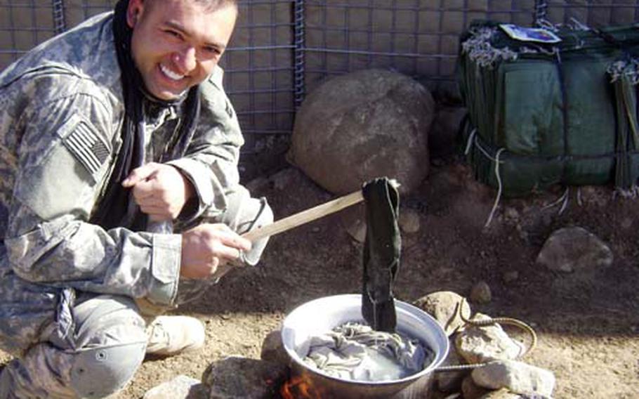 Army Reserve Spc. Gregory S. Ruske operates an improvised “washing machine” at Forward Operating Base Morales-Frasier after his unit’s laundry was delayed in December 2007.