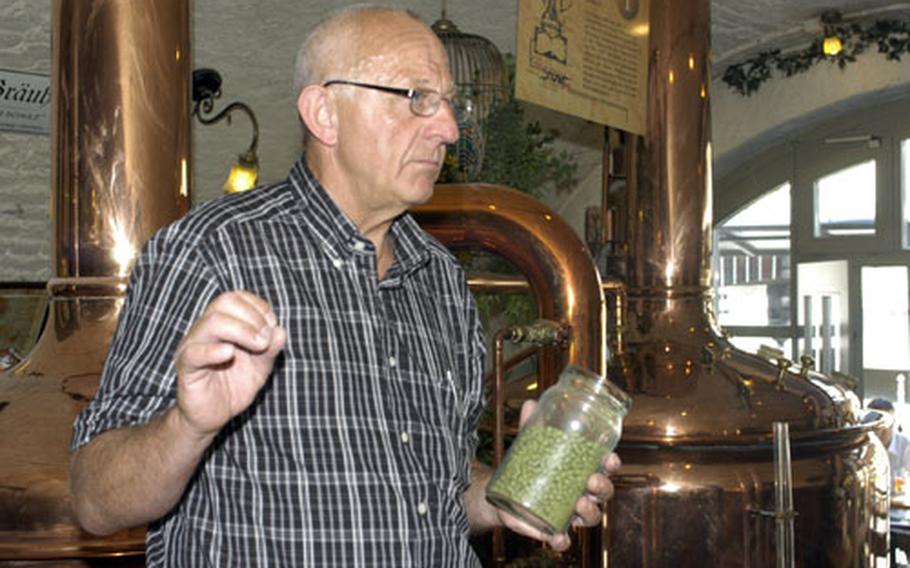 Burghardt Kühn, brewmaster at the Eisgrub-Bräu, holds a jar of hops as he gives a tour of his brewery. Kühn explained that the grassy smelling hops are used in his beer to add bitterness and flavor.