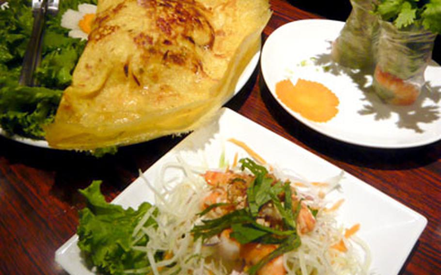 Dishes at Lotus Palace are appealing to both the stomach and the eyes. From the left are shrimp and pork banh xeo, goi cuon with avocado and goi du du.