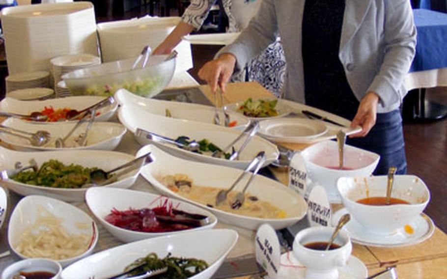 Diners load up on healthy organic vegetables at Casa Verde&#39;s salad bar.