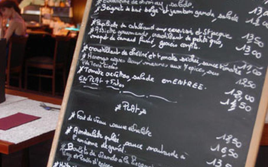 Because the menu at L’Imperatif&#39;Ment Belge in Mons, Belgium, changes each day, the daily offerings are written on a chalkboard.