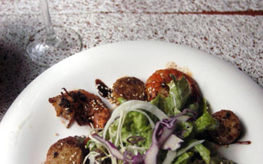 Lightly seasoned with a red pesto sauce, this appetizer consists of crawfish and scallops.