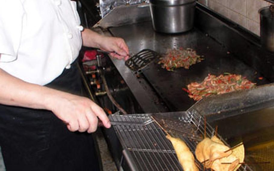 Chef Alejandro Gayosso prepares a meal at La Casa Del Mexicano. All the restaurant's chefs are from Mexico City.