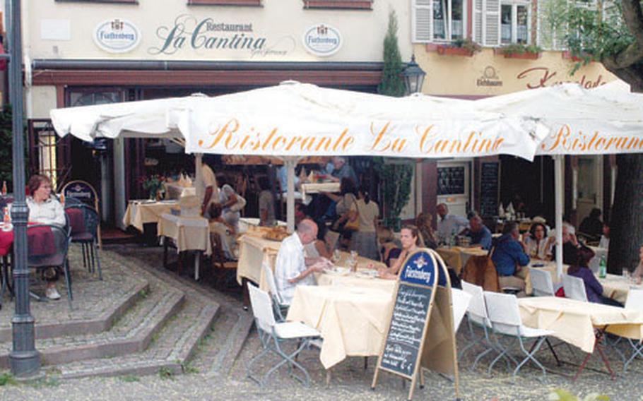 Huge umbrellas shade La Cantina patrons as they enjoy food and drink outside the restaurant on the marketplace in Weinheim.