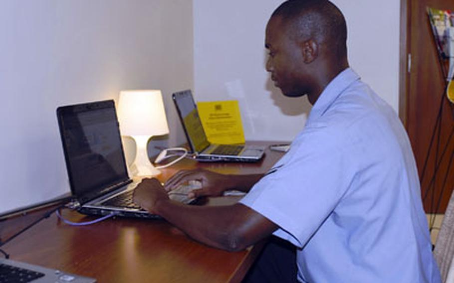 Far left: Petty Officer 2nd Class Steven Burke, a boatswain mate, uses a computer to check e-mail at the United Service Organizations center at Capodichino in Naples. Burke, 28, of Fort Lauderdale, Fla., is also a volunteer with the USO. He has helped organize social events for servicemembers in Naples.