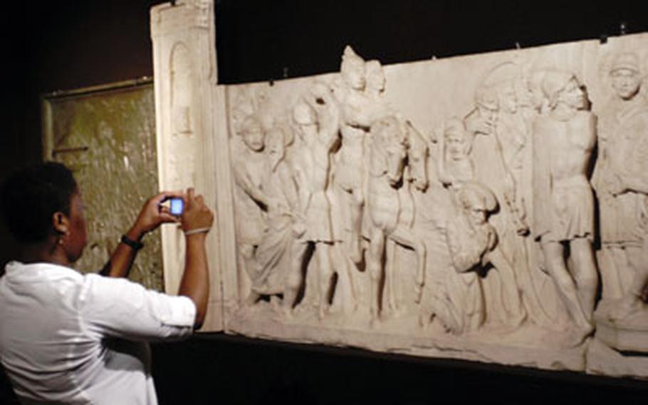 A visitor to the Vatican takes photos in one of its museums. The Vatican is around the corner from the USO center in Rome. The USO can help travelers with tours of the Vatican and other famous sites in the city.