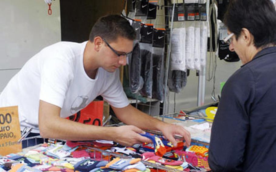 Giancarlo Ceolotto sells socks — hundreds of them — from a stall.